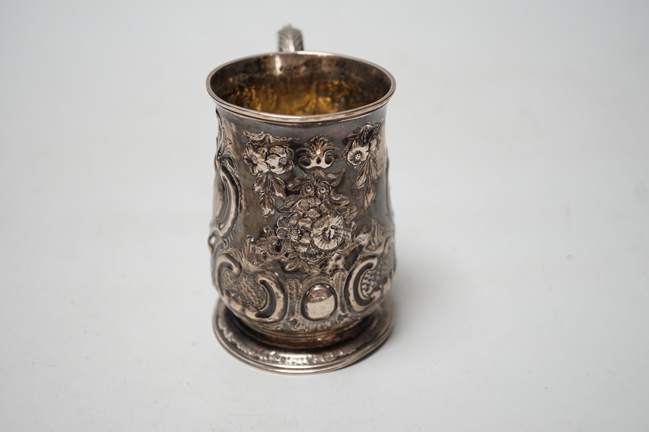 A George III silver small mug, with later embossed decoration, William Cripps, London, 1775, 95mm, 6.1oz.